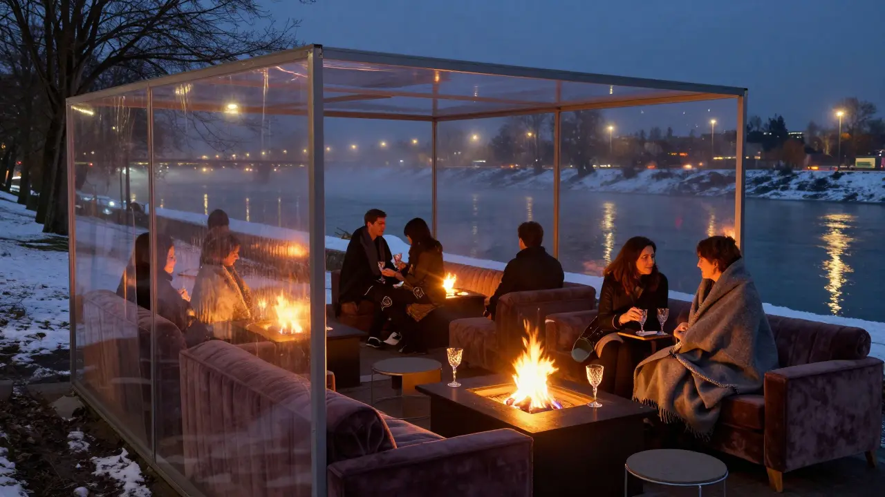 Cozy heated terrace on the Isar River with fire pits and patrons bundled in blankets.